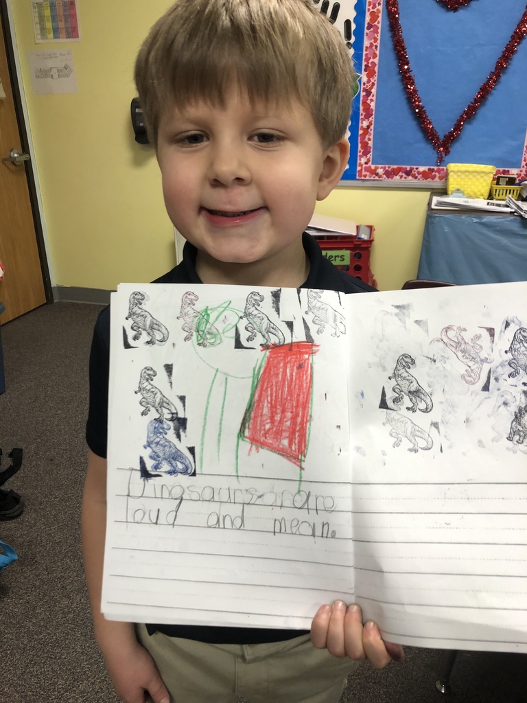 Student holding up his writing activity