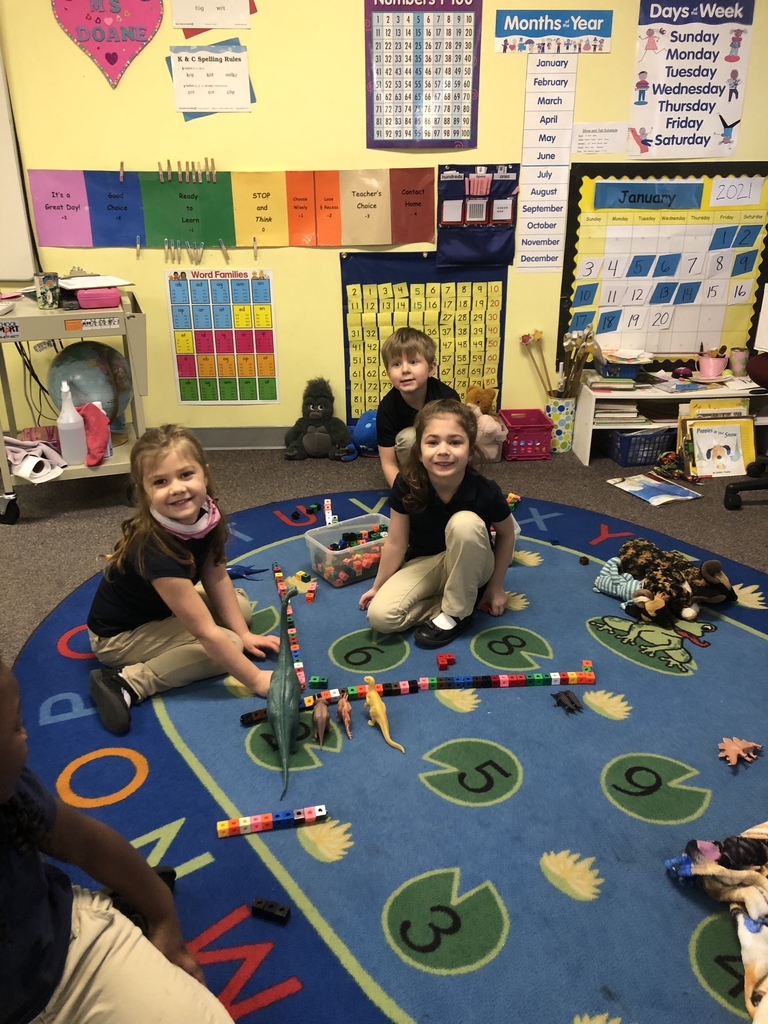 Students playing with dinosaurs